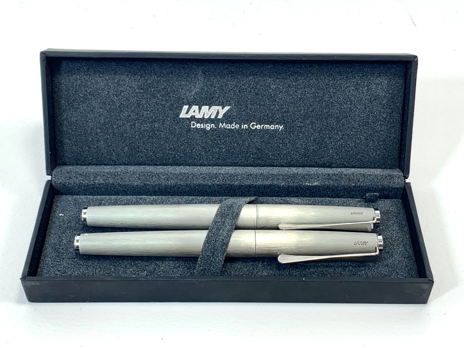 Lamy Germany Brushed Silver and Chrome Fountain and Ballpoint Pen Set w/Box: Excellent single use condition, with no defects. Approx. 5 1/2". Glossy finish throughout. Box may show moderate shelf wear, and may include ink stains. Please enlarge pictures to clearly understand b