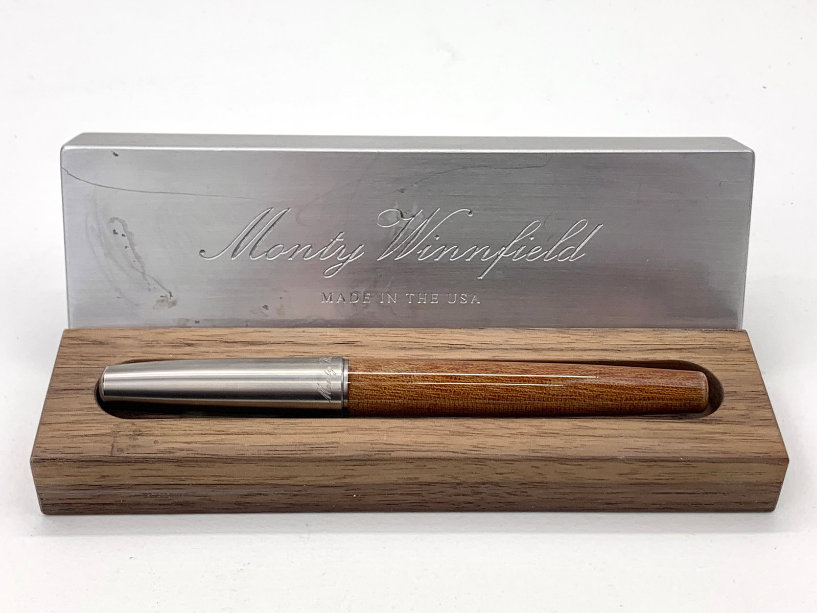Monty Winnfield USA Brown and Brushed Steel Fountain Pen w/Box: Excellent single use condition, with no defects. Approx. 5 7/8". Glossy finish throughout. Box may show moderate shelf wear, and may include ink stains. Please enlarge pictures to clearly understand b