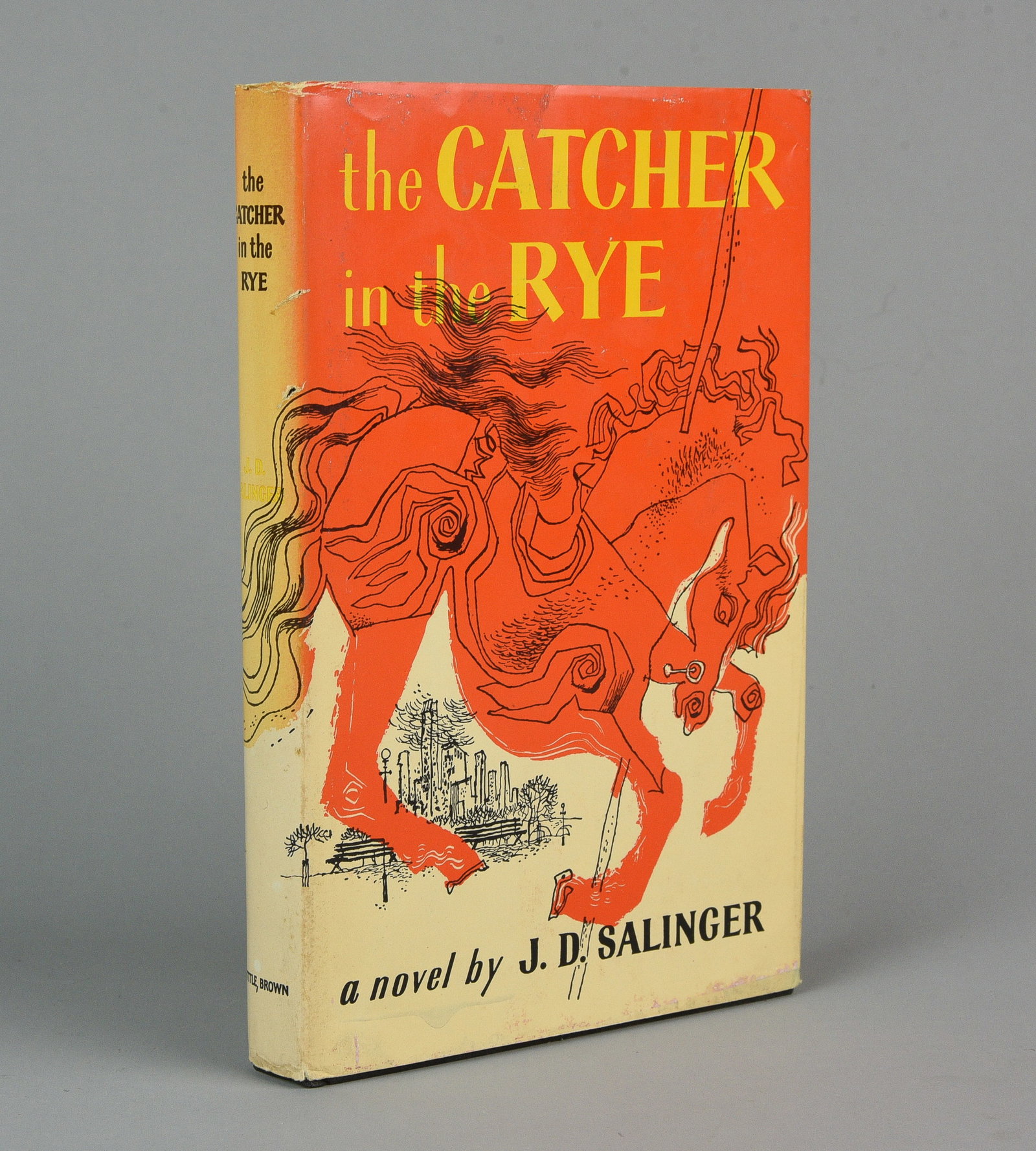 Catcher In The Rye, Salinger, J. D. Book Club Edition 1951: Catcher In The Rye by J. D. Salinger. Boston: Little Brown and Company, 1951. Book Club Edition. Black cloth, spine lettered in gilt, pictorial jacket. Jacket spine sunned, paper loss to the rear pane