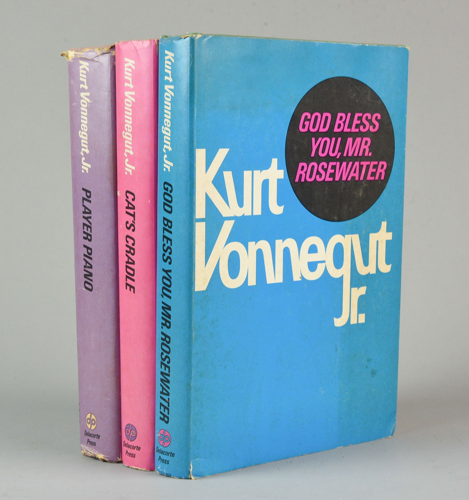 Three Kurt Vonnegut Books-Cat's Cradle, Player Piano, and God Bless You, Mr. Rosewater 1971: Three Kurt Vonnegut Books: Cat's Cradle, Player Piano, and God Bless You, Mr. Rosewater. Good condition with marks, edgewear, and other wear to jackets, some books with bowed boards and other wear.