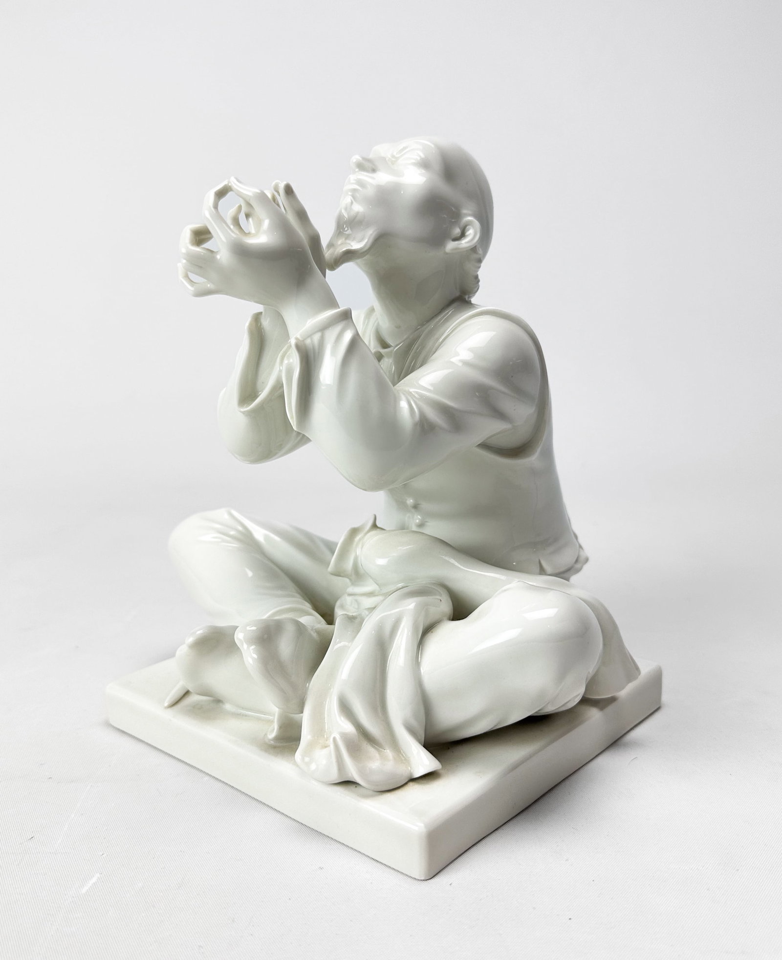 Meissen Blanc de Chine Porcelain Figurine "Chinese Tailor" Statue: Meissen Blanc de Chine Porcelain Figurine "Chinese Tailor" Statue. Ca. 20thC. Very good condition, with a tiny nip on the end of coat. Otherwise free of any chips, cracks, or repairs. We Do Not Provid