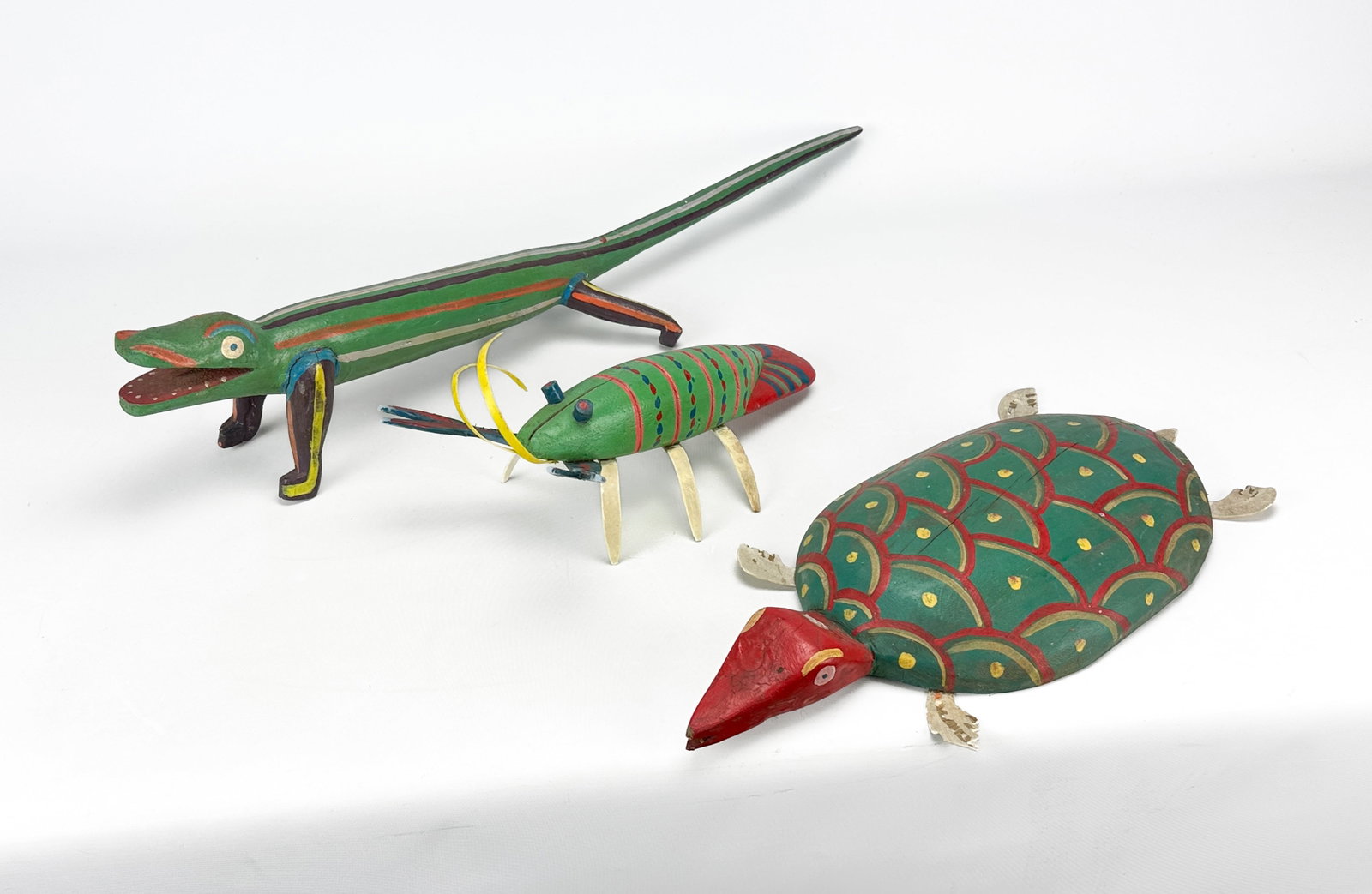 Three Rafael Morla Painted Wood Folk Art Lizard Turtle & Lobster Sculptures: Three vintage South American folk art sculptures by Dominican artist Rafael Morla. Each sculpture signed and dated on underside. Lizard in good condition with some cracks and paint damage. Lizard meas