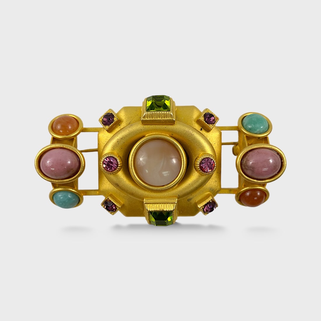 Natasha Stambolli Gold Tone Semi-Precious Cabochon Stone Brooch: Approx. 2 5/8” x 1 1/8”. Good preowned condition. Shipping: We do not provide in-house shipping or packing. Please reach out to one of our preferred shippers for a quote: Donald Camden UPS
