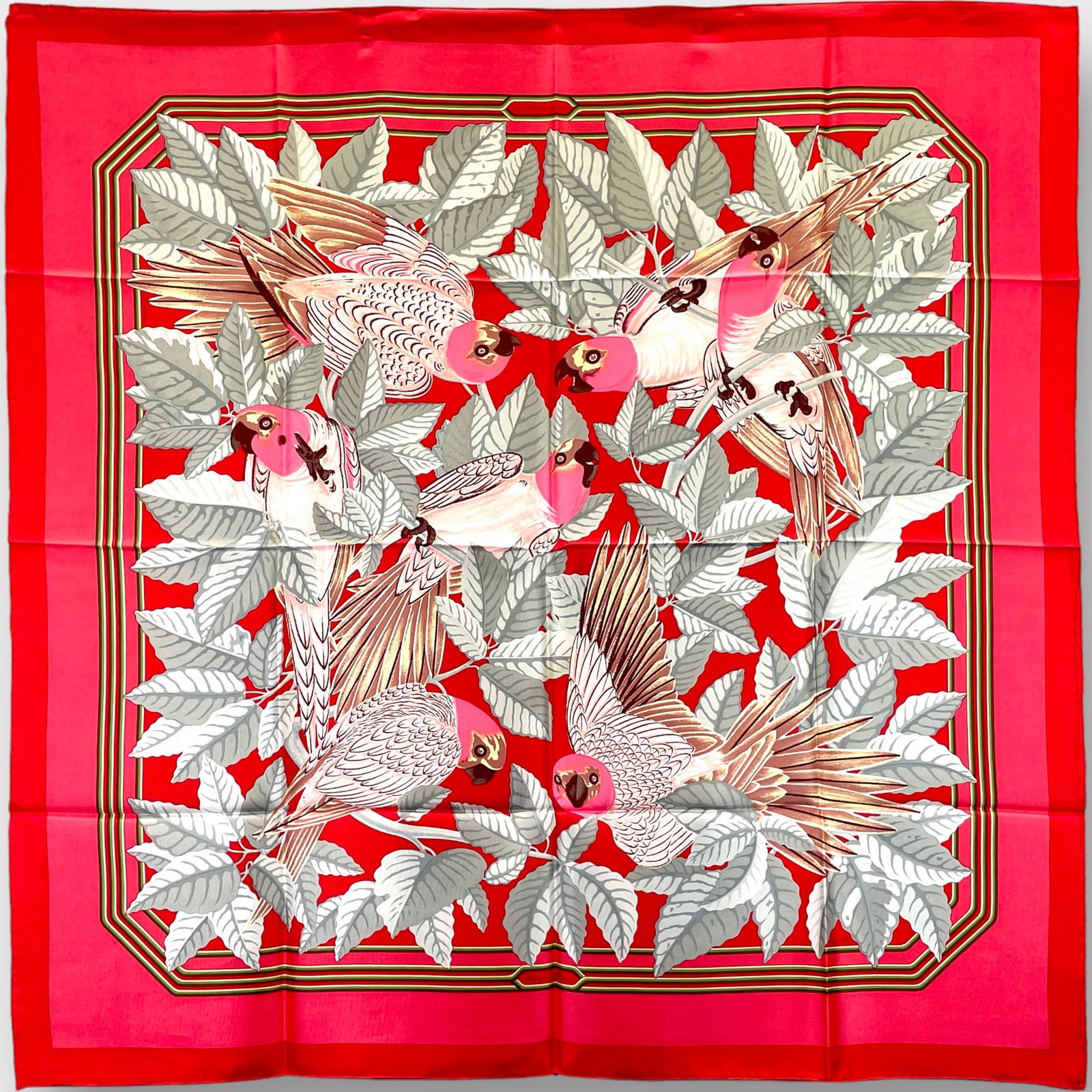 HERMES Silk “Les Perroquets?? Scarf, Red, Salmon and Grey: Preowned, excellent condition, no visible imperfections Shipping: We do not provide in-house shipping or packing. Please reach out to one of our preferred shippers for a quote: Donald Camden UPS Store