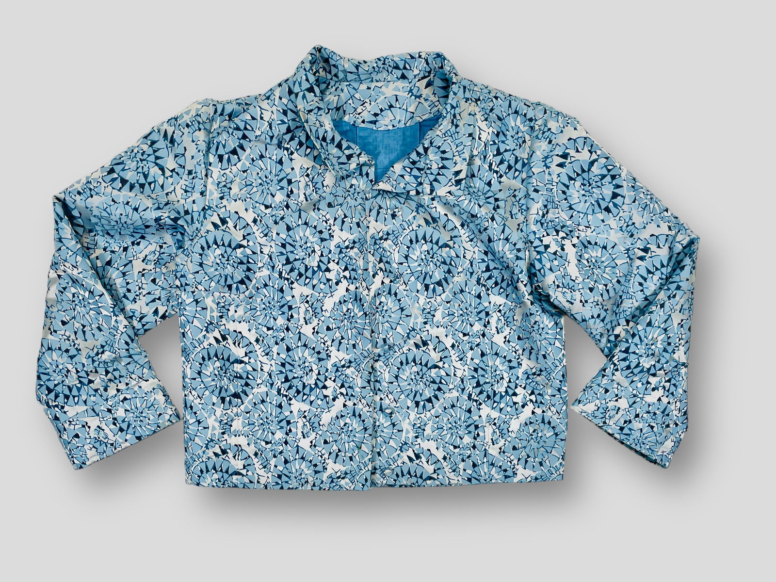 Light Blue Metallic Kaleidoscope Print Silk Button Down Jacket with Pockets and Blue Linen Lining.: Measurement taken flat. Shoulders 16" Chest 22" Shipping: We do not provide in-house shipping or packing. Please reach out to one of our preferred shippers for a quote: Donald Camden UPS Store #4608 s