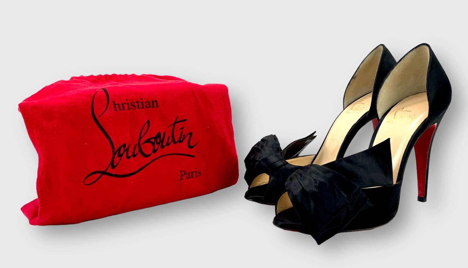 CHRISTIAN LOUBOUTIN Black Satin Bow d'Orsay Pumps: Barely worn. Size 40 1/2. Shipping: We do not provide in-house shipping or packing. Please reach out to one of our preferred shippers for a quote: Donald Camden UPS Store #4608 store4608@theupsstore.c