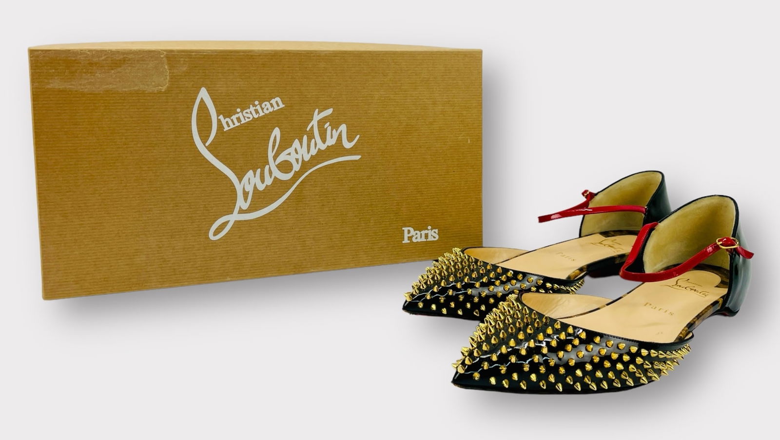 CHRISTIAN LOUBOUTIN Black Patent Baila Goldtone Spiked Flats with Red Ankle Strap. Size 41.: Great preowned condition, outsoles have some wear Shipping: We do not provide in-house shipping or packing. Please reach out to one of our preferred shippers for a quote: Donald Camden UPS Store #4608
