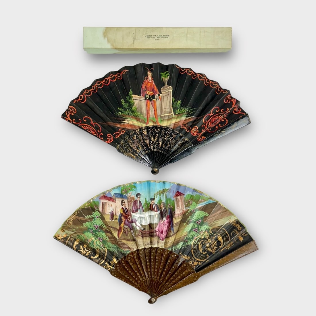 JOHN WANAMAKER NEW YORK- PHILADELPHIA-PARIS Box Containing 2 Vintage Hand Fans. Natural Wood and: Box has stains. Fans are very delicate and have flaws.