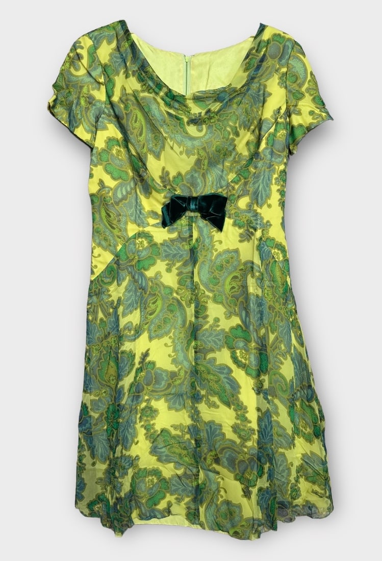 Vintage Party Dress. Green and Yellow Floral Chiffon over Yellow Silk with Green Velvet Bow.: Small moth holes in fabric. Measurement taken flat. Shoulders 15 in. Chest 18 in. Waist 16 in.