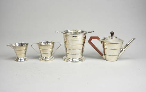 Keith Murray Original Art Deco Silverplate Tea Set & Ice Bucket w/Stepped Side Design: Ca. first half 20thC. Very good with no major breaks, dents or repairs. Except for the sugar, which is missing the handle. The set includes a 5 1/2" tall by 9 1/4" wide teapot, a 3 1/4" sugar and 3 1/