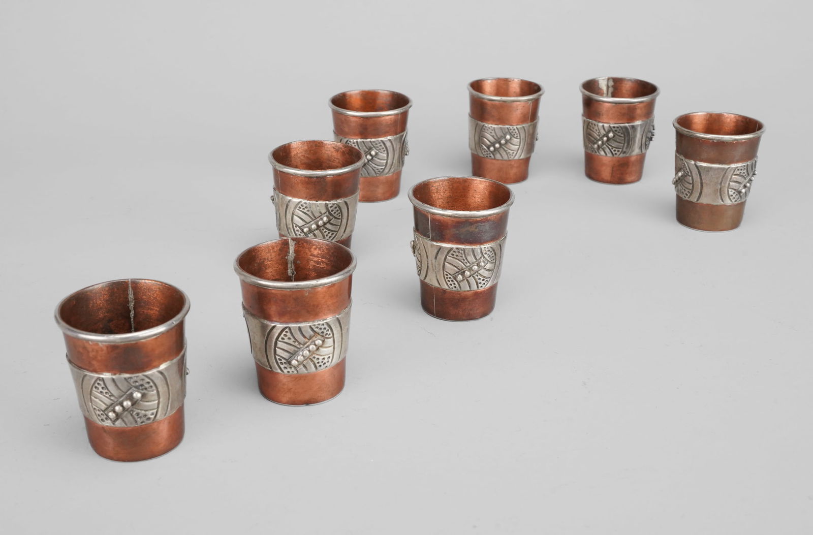 Set of Eight Victoria Sterling Silver and Copper Mexican Shot Glasses: Ca. Mid 20thC. All remain in very good original condition only needing polish. No dents, dings, or repairs. One shot glass is slightly out of round otherwise excellent. Each shot glass measures approx