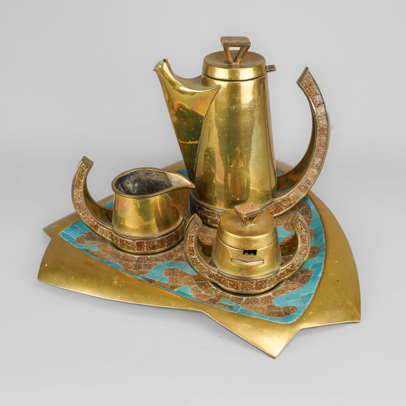 Salvador Mexican Handwrought Brass and Glass Mosaic Tile Inlaid Coffee/Tea Pot Set on Tray: Ca. Mid 20thC. Excellent original condition with no cracks, chips, breaks, or repairs. Sugar bowl retains scarce original spoon & lid. Sugar bowl shows one small ding. Otherwise, complete and fine. Tr