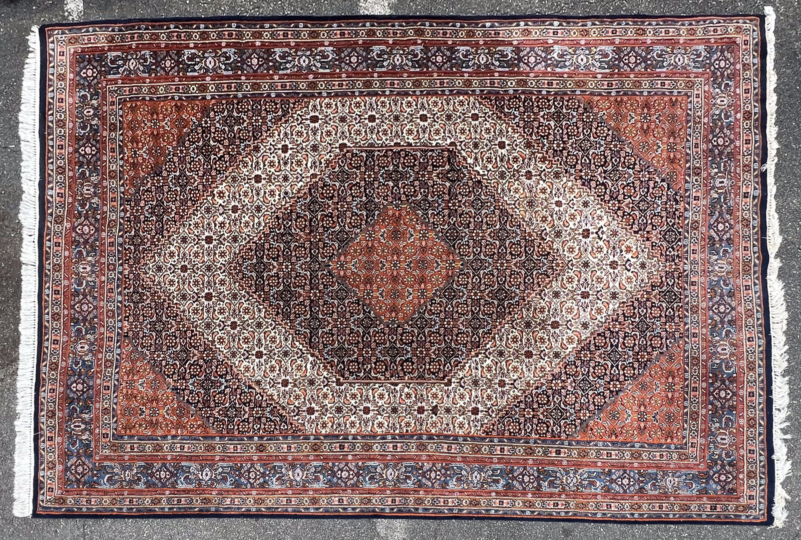 11' Persian Hand Knotted Area Rug: 11' Persian Hand Knotted Area Rug. Fair to good overall condition. See photos of damaged fringe. In need of cleaning, light odor. We Do Not Provide In-House Shipping! Please reach out to one of our pr