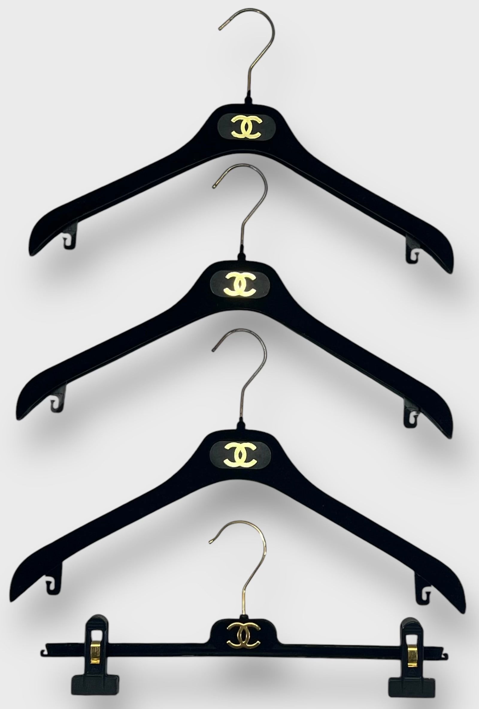 CHANEL Vintage Flocked Velvet Hangers with Goldtone CHANEL Insignia: Lot of 4 (1 is a Skirt Hanger). Preowned, sold as is.