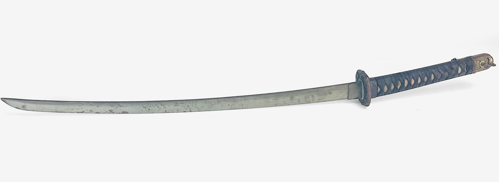Antique Japanese Samurai Sword Fitted w/Tsuba & Partial Shagreen/Wood Handle: Ca. 19th/20thC. Light to moderate rust on the sword, only partial shagreen handle remains. We are unable to remove the handle without removing the cloth, so it is sold as you see it.