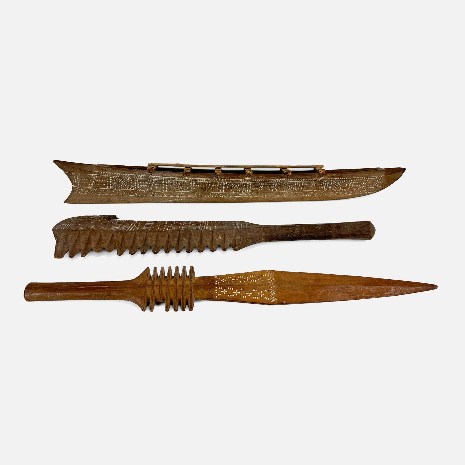 Samoan Tribal Carved Paopao Canoe Boat Model and Two Samoan Oceanic Wood War Clubs Anave Nifi'oti: All items of this lot have and estimated age around mid 20th. 34 1/2" model canoe appears to be missing outrigger piece. Otherwise canoe in fair condition with shown surface wear and lime filling loss