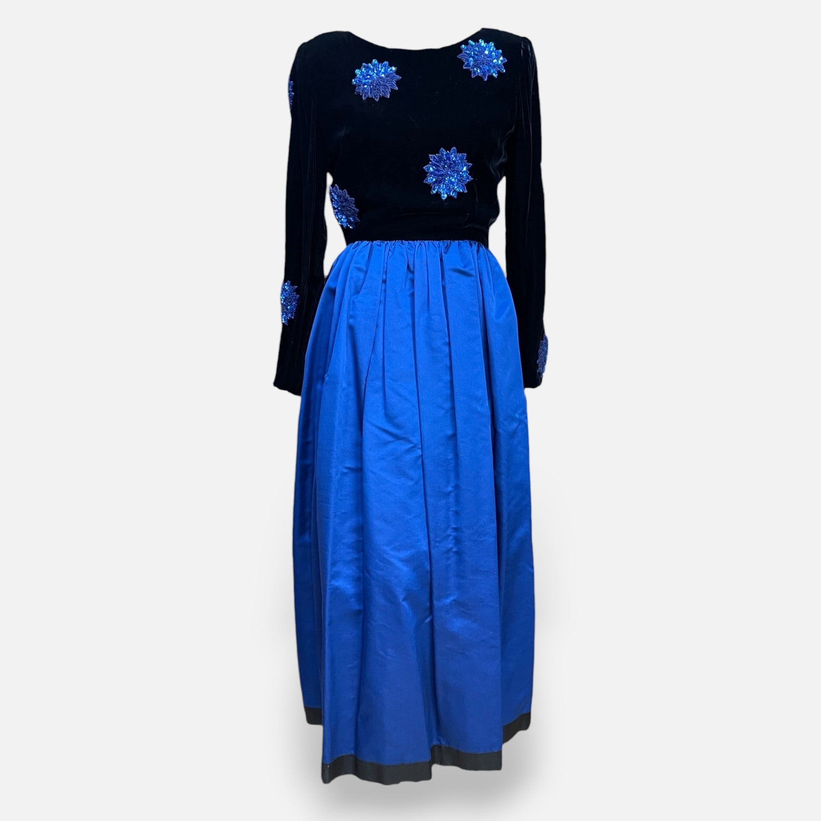 William Pearson Velvet and Satin Evening Dress From Saks Fifth Avenue: One piece lack velvet bodice with blue floral sequin embellishments, paired with a royal blue satin full skirt. Made in collaboration with Saks Fifth Avenue, excellent condition. Measurements taken fl