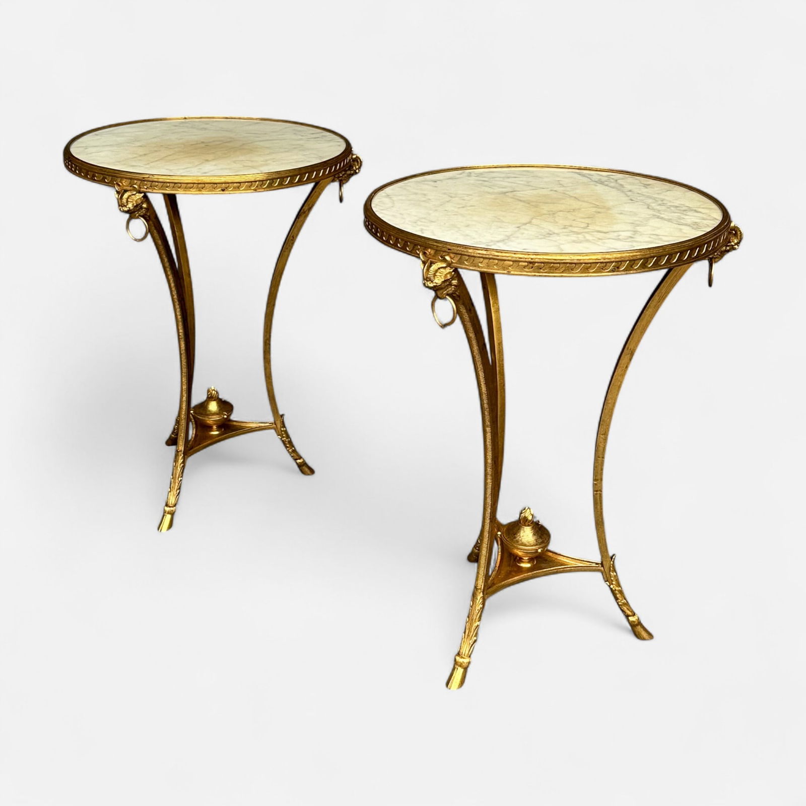 Pair Antique White Marble and Gilt Brass Gueridon Tables w/Goat Hoof Feet and Goat Head Decoration: Ca. first 20thC. Excellent age-appropriate condition, with no apparent breaks or repairs. No bends. No cracks or chips to marble. Simple integrated shipping with LiveAuctioneers LiveShipping is now av