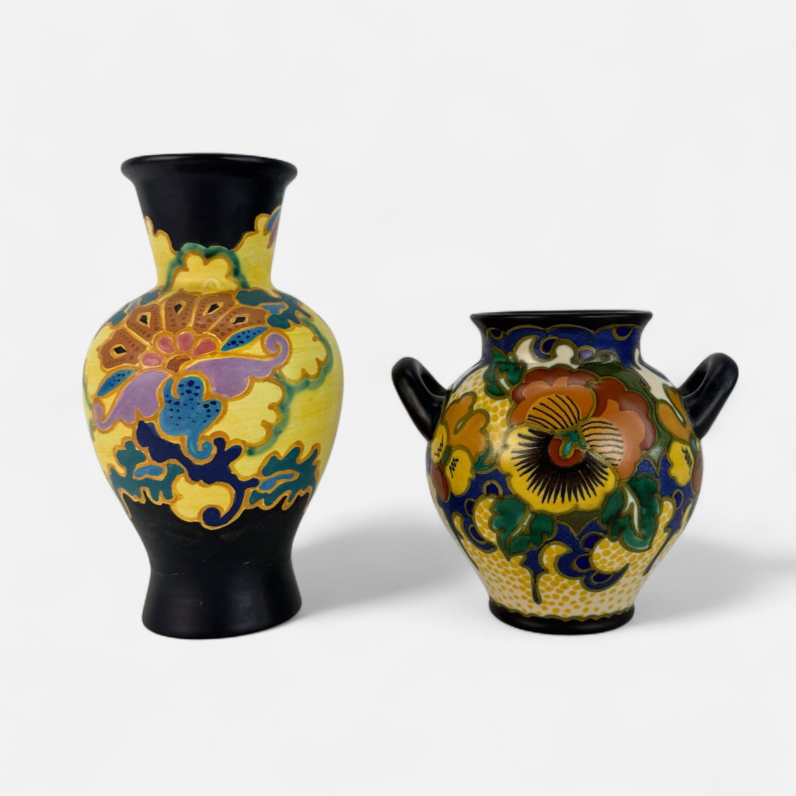 Two Gouda Zuid Holland Art Pottery Vases #1: Taller vase measurements included in listing. Smaller vase measures approx. 6 1/2" x 7 1/4". Good overall condition, with spots of discoloration and smudges to glaze, glaze crack near base of taller v