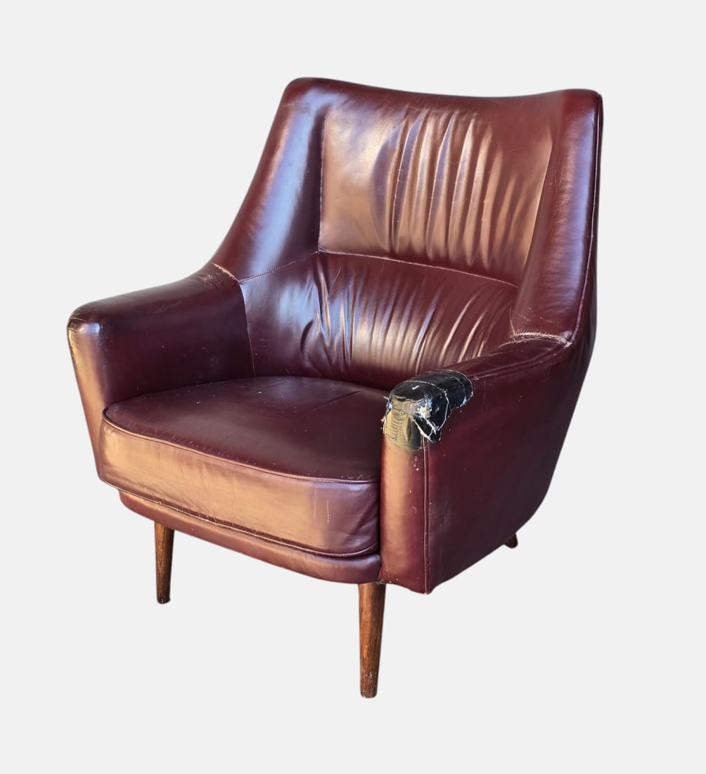 Mid Century Modern Leather Lounge Chair: Ca. 1960s. In need of reupholstery, age-appropriate scuffs and wear to legs namely rear (see photos).