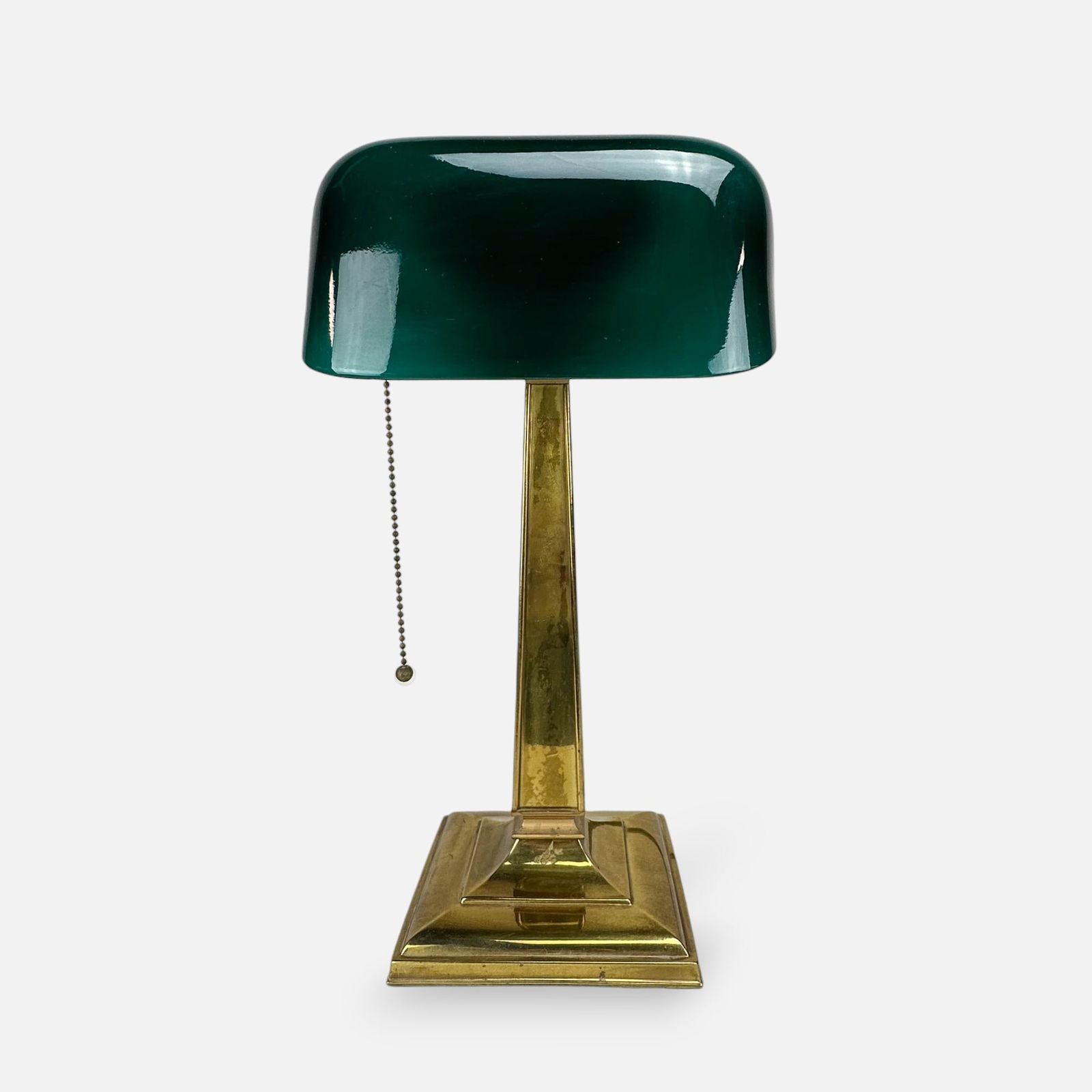 McFaddin & Co "Emeralite" #8734 Bankers Desk Table Lamp w/Cased Green Shade: Ca. first third 20thC. Very good original condition throughout. The brass base needs cleaned and polished if you want this to look brand new. The original cased green shade is excellent with no chips