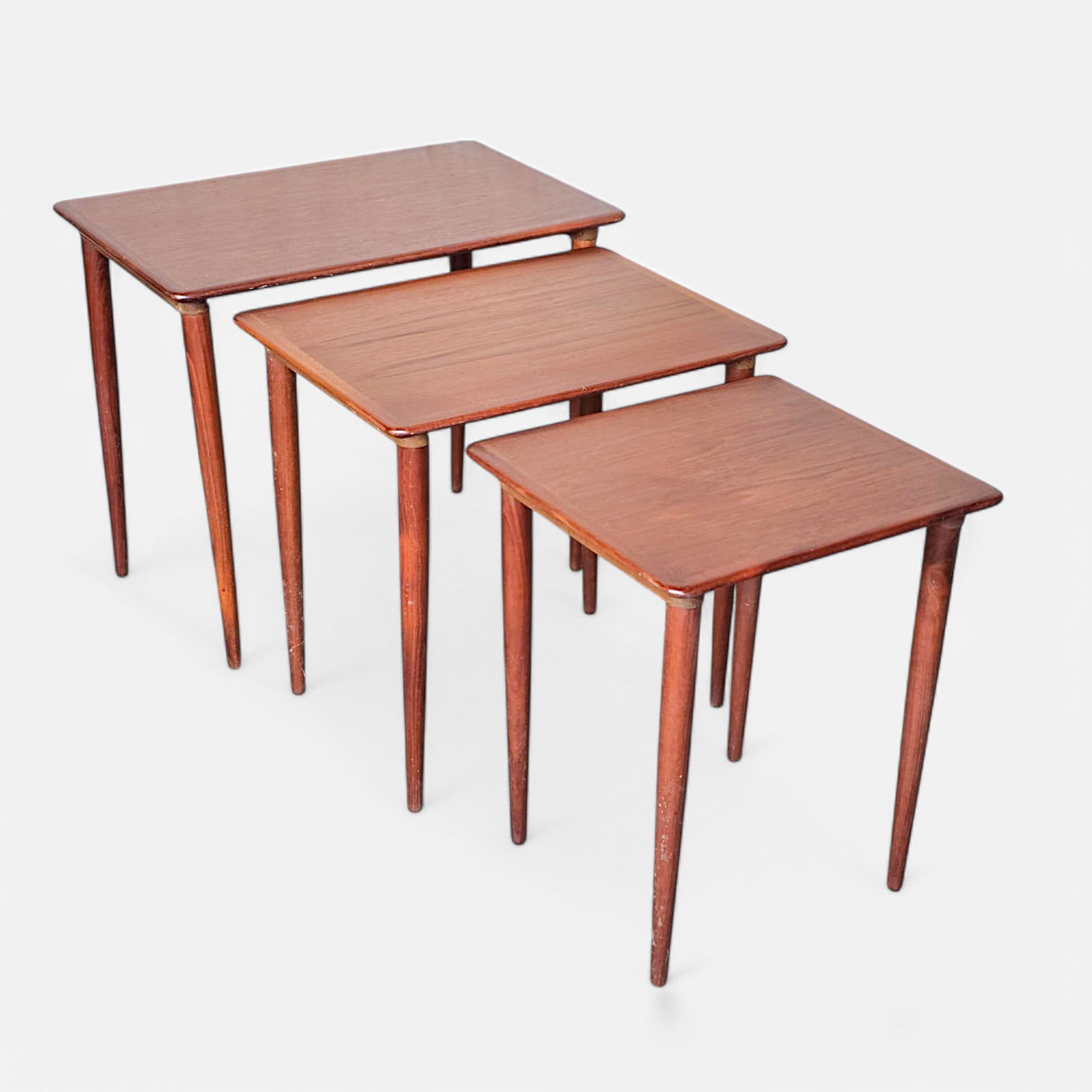 Three Danish Modern MCM Teak Nesting Tables: Good as shown, with minor age-appropriate surface wear.