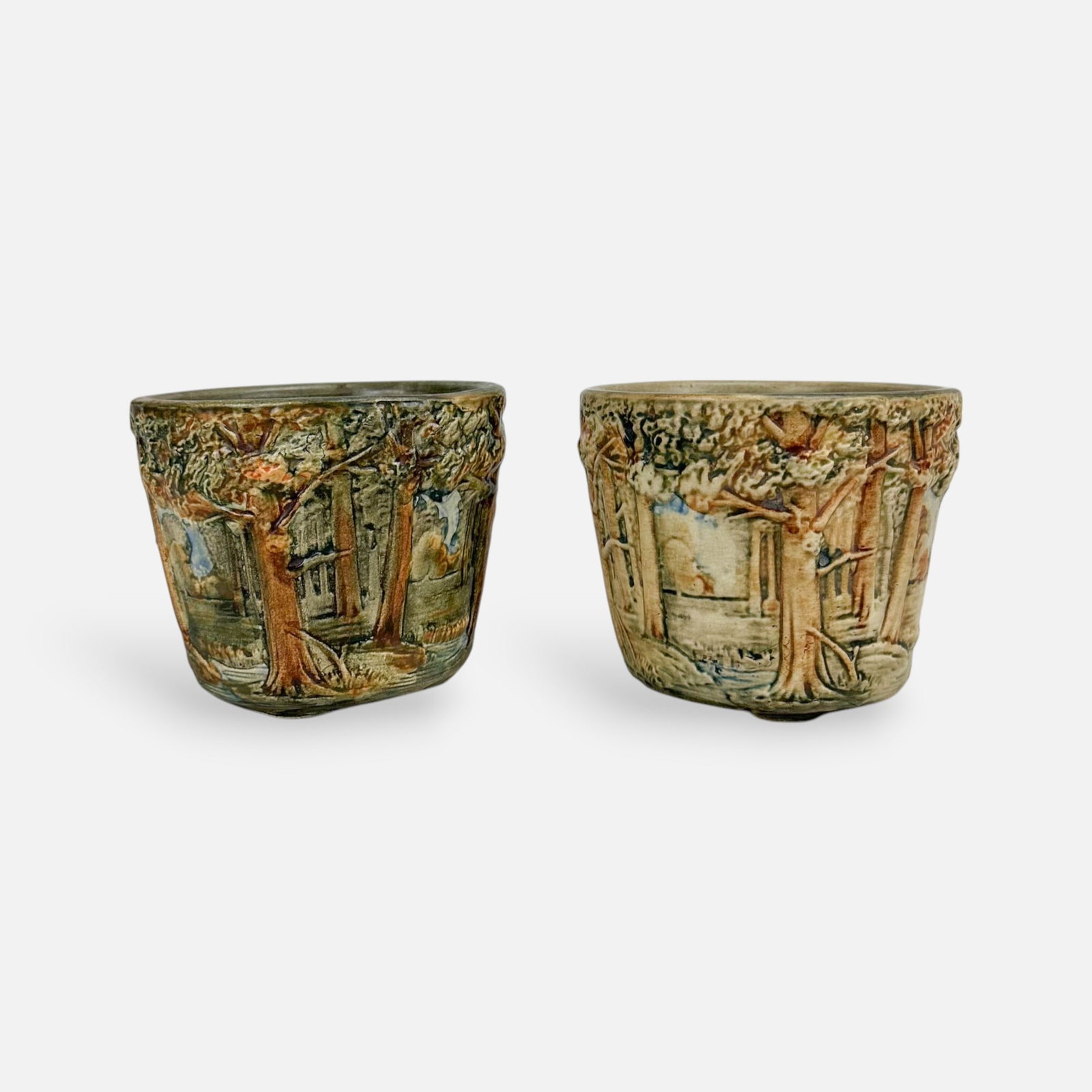 Pair Weller Art Pottery Forest Pattern Footed Bowls Round Planters: Ca. first quarter 20thC. Very good with no chips, cracks or repairs. Needs cleaning. Previous owner planted flowers in both. Crazing as typical throughout.
