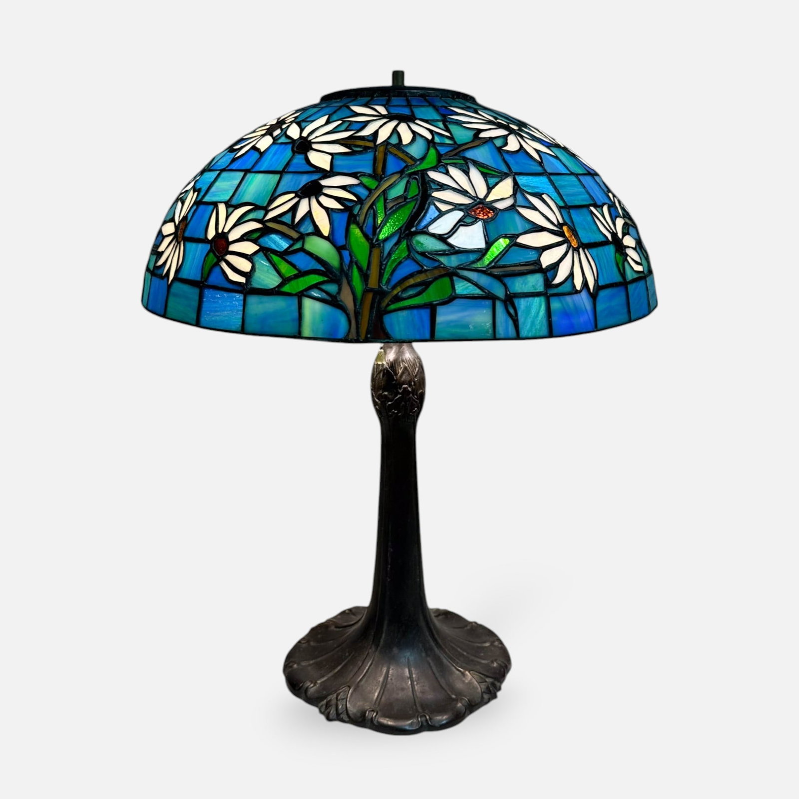 Contemporary Tiffany Style Leaded Glass Black Eyed Susan in Daisy Colors Table Lamp: Very good as shown, with no breaks, cracks, or repairs. Appears to be unmarked. Shade measures approx. 7 1/2" x 16". Base measures approx. 20 1/2" x 7".
