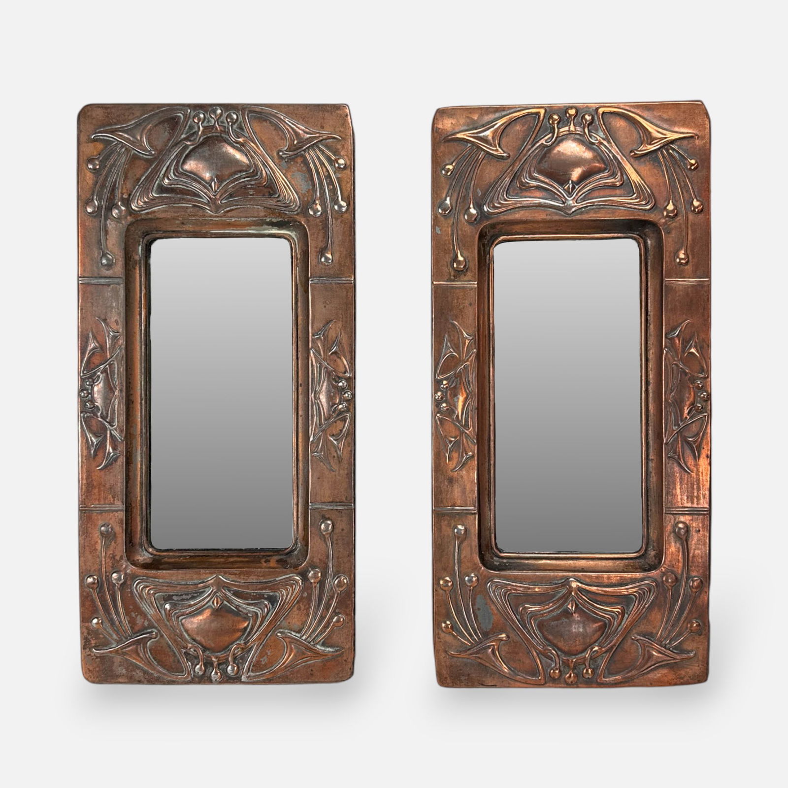 Pair Small Art Nouveau Repousse Copper Matched Wall Mirrors: Good as shown with surface loss. Mirror panel measures approx 7 1/2" x 3 1/2".