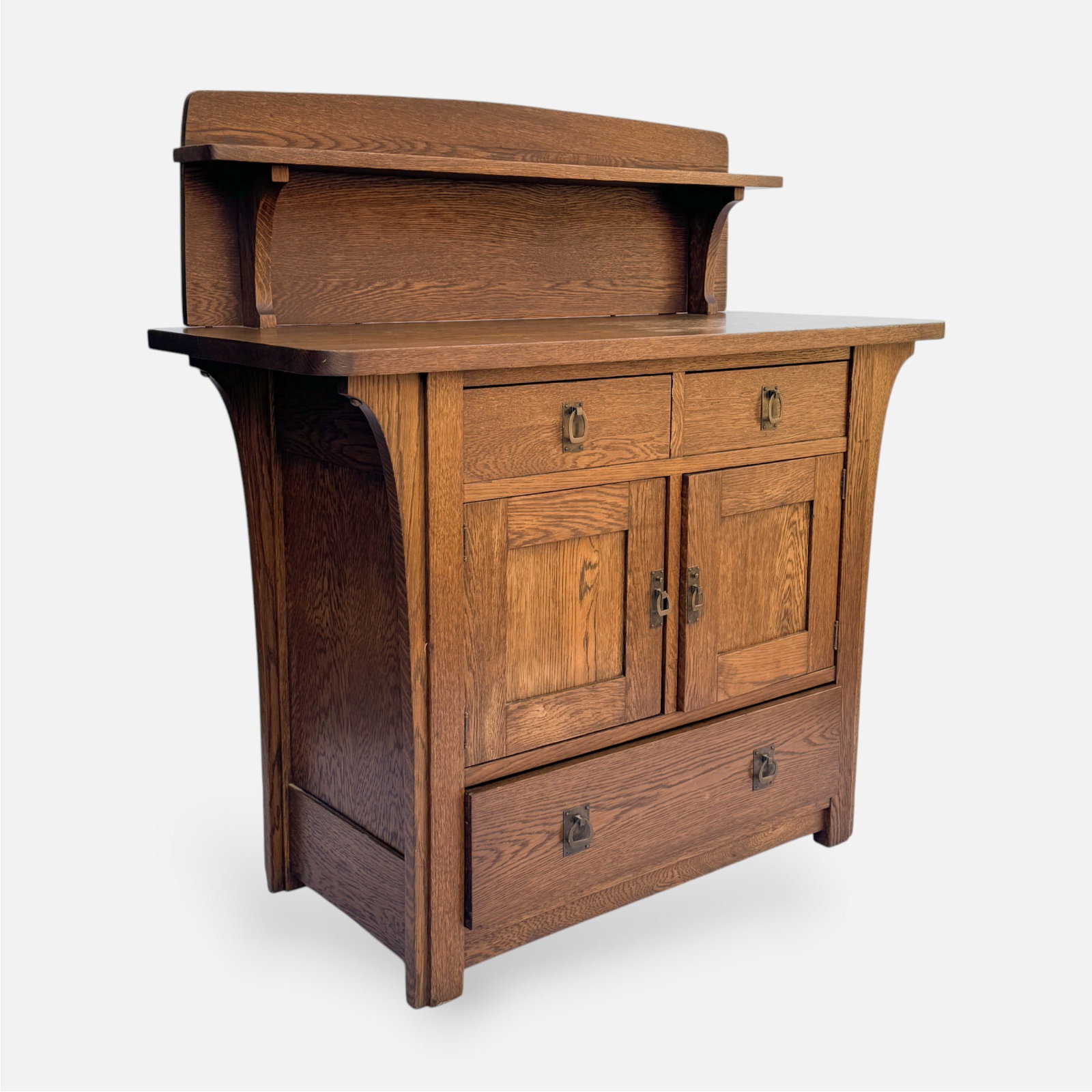 Limberts Arts & Crafts Mission Oak Sideboard w/Back Splash: Ca. early 20thC. Very good age-appropriate condition. Retains original finish, with a partially cleaned top. Otherwise, fine, without any breaks or repairs. Paper label on reverse.