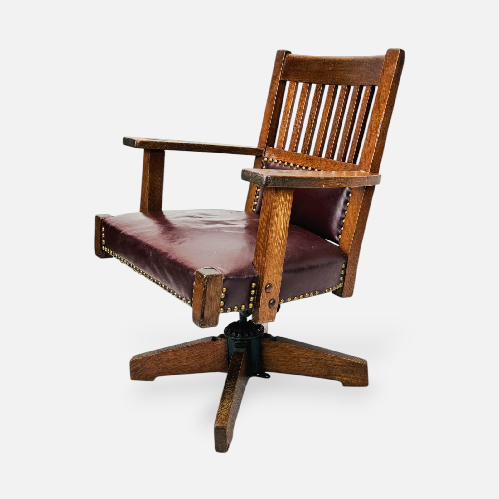 Arts & Crafts Mission Oak Leather Swivel Desk Chair: Fair to overall condition, with moderate wear consistent with age and use. Shown minor cracking to leather seat. Discoloration to left arm. One missing stud to right side.