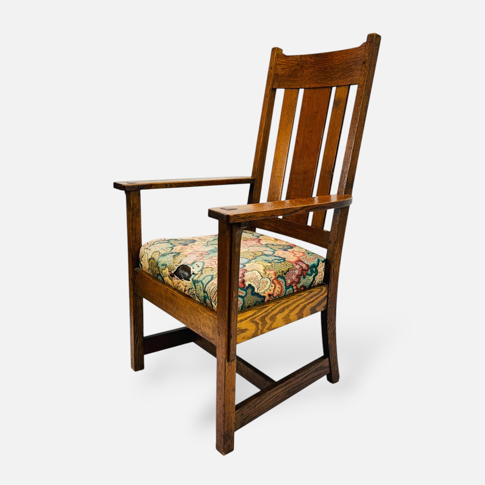 Antique Arts & Crafts Mission Oak Armchair: Good overall condition, with wear consistent with age and use. Tear to seat cover. Appears to have the original seat under the floral fabric. Approx. seat height 18".