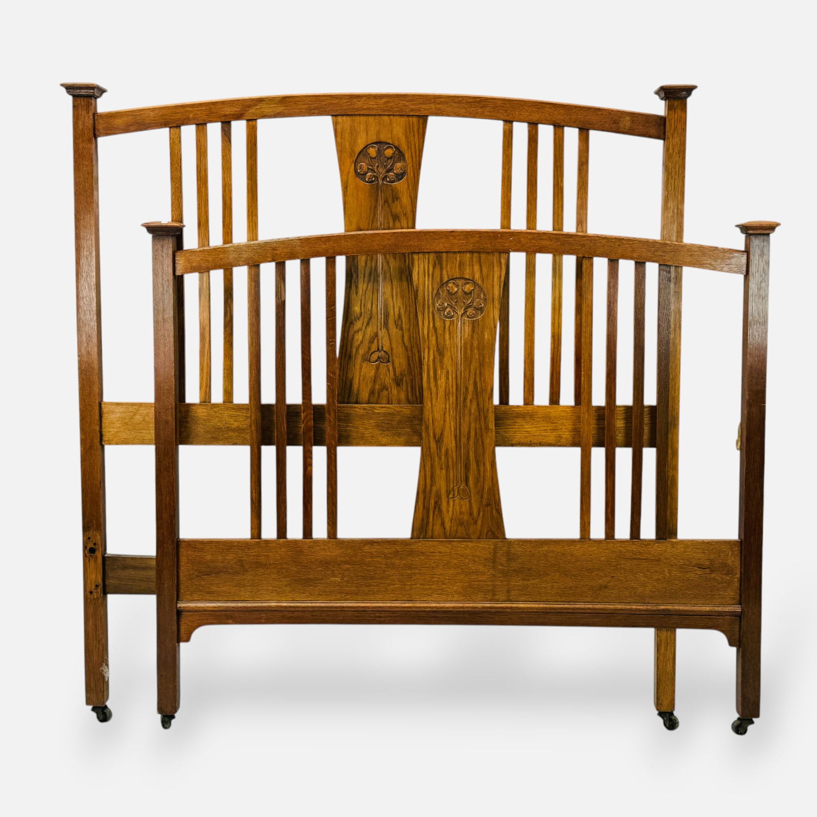 Liberty & Co Arts & Crafts English Oak Carved Wood Full Headboard & Footboard: Ca. early 20thC. No bed rails. Good overall condition, with minor age-appropriate surface scuffs, scratches, and discoloration. Presently on wheels.