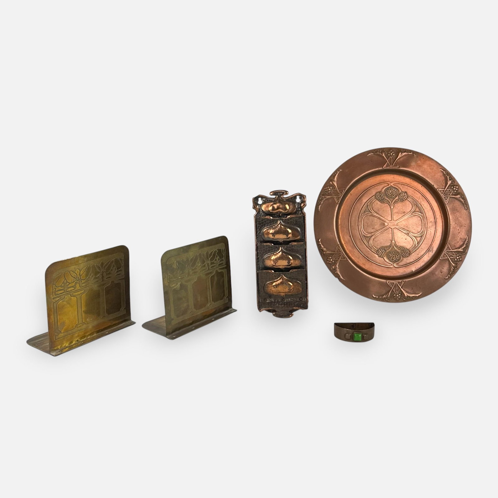 American & European Arts & Crafts Metalwork Five Pieces Bookends, Tray, Letter Holder, Napkin Ring: Good with age-appropriate surface discoloration and minor wear. WMF charger measures approx. 11 1/2". Wall hanging letter holder measures approx. 9" x 3 1/2". Napkin holder approx. 3/4" x 2 1/2" x 1 1