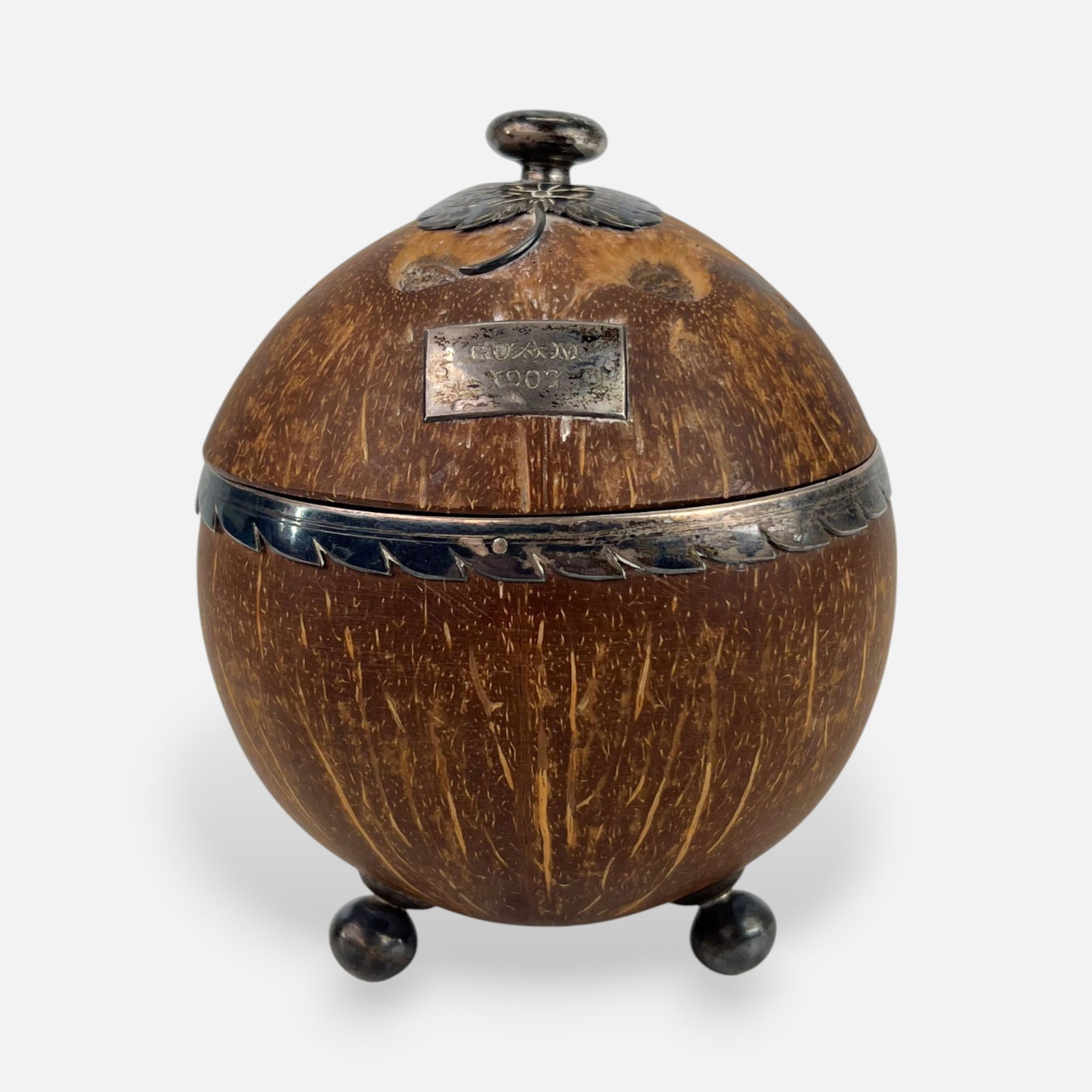 Antique Silver-Mounted Coconut Box From Guam: Ca. early 20thC. Engraved "Guam 1907" to front plate. Age-appropriate surface wear and discoloration. Free from any breaks or repairs.