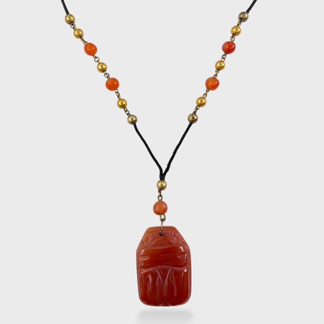 Fine Carved Carnelian Egyptian Revival Scarab Pendant Necklace 19.5 Inch: Gold plated beads. Good condition. Rope cord. Pendant drop measures approx. 2 3/4 inch. We do not provide in-house shipping! We have a partnership with our local UPS Store which offers a simple pack a