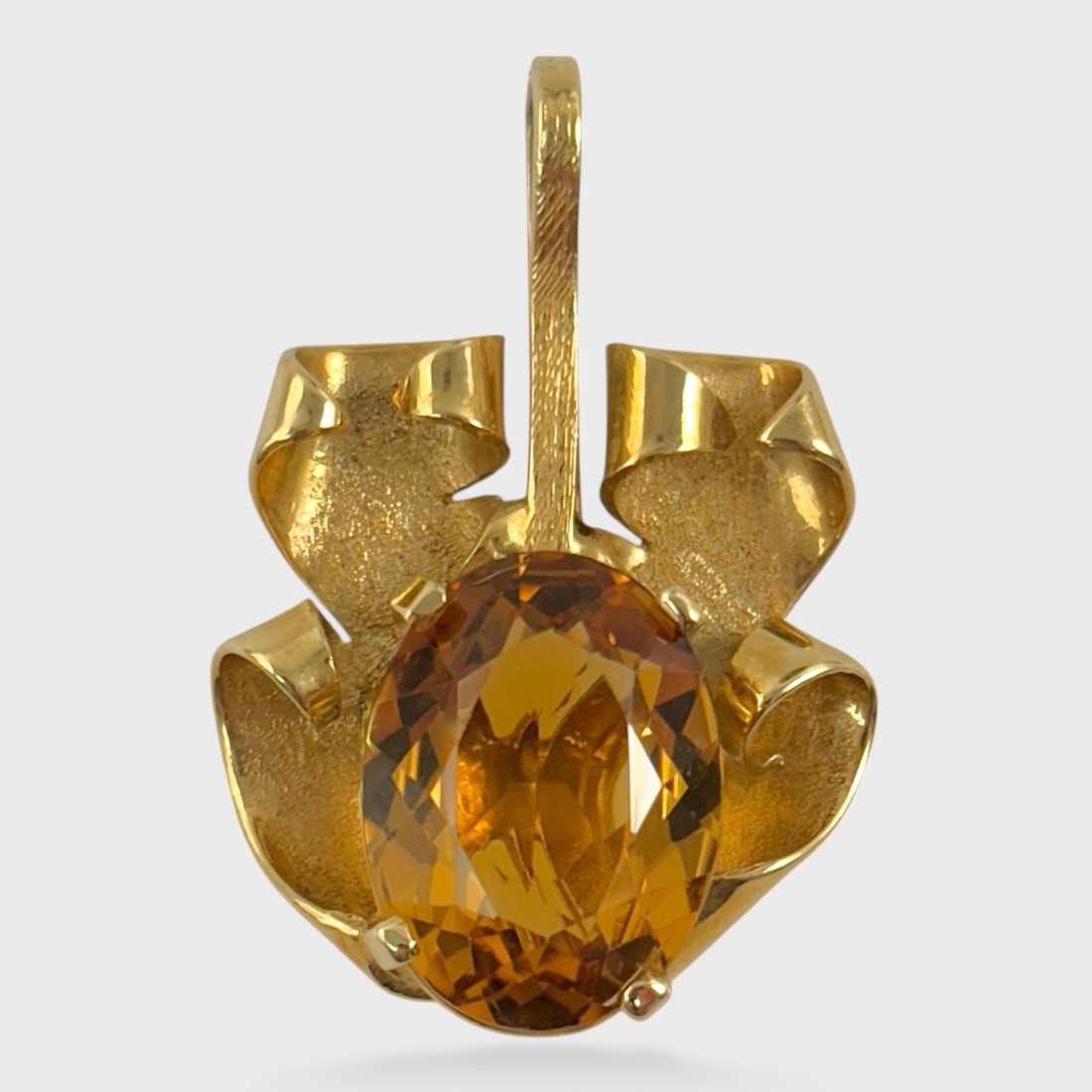 Fine 18K Yellow Gold & Oval Cut Citrine Pendant: Heavy gold modernist setting. Weighs approx. 8.8 grams. Drop measures approx. 1 3/8". Measures approx. 1" wide. Stone measures approx. 16.5 mm x 12 mm We do not provide in-house shipping! We have a pa
