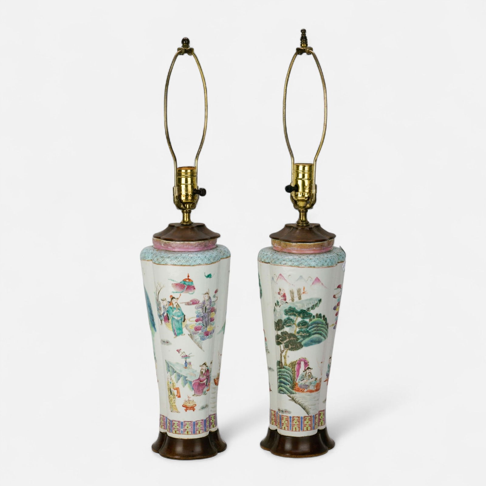 Pair Antique 19thC Chinese Porcelain Famille Rose Four-Lobed Lamps: Ca. 19thC. Good condition, with no chips, cracks, or repairs. The porcelain sections measure approx. 13" high. Carved wood clover shaped plinth base.For shipping, we highly recommend Donald Camden at