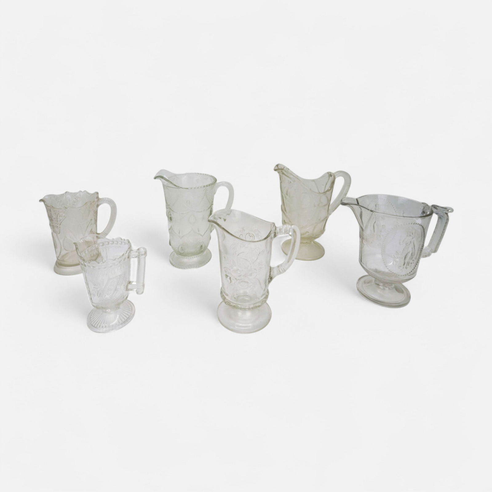 Six EAPG Water Pitchers #1 Early American Pressed Glass: Ca. last quarter 19th to first quarter 20thC. Please enlarge all pictures for best condition report. We did not intentionally include any glass with cracks or chips. For shipping, we highly recommend