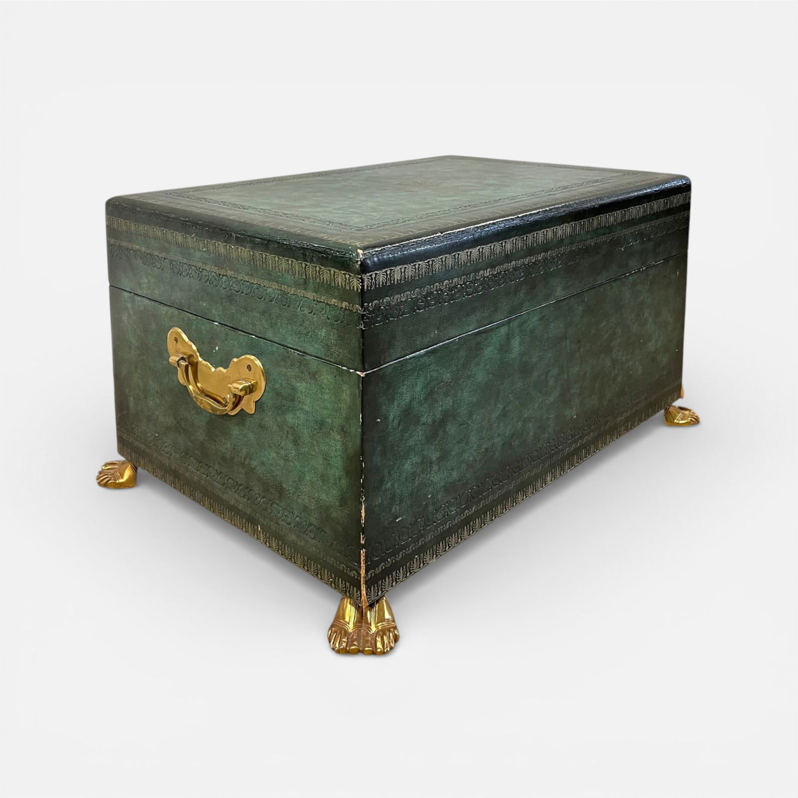 Decorative Small Trunk Wrapped in Green Embossed Leather w/Brass Handles and Sandaled Feet: Interior lined with Florentine marbleized paper, leather strap. Good overall with shown minor dings, discoloration.For shipping, we highly recommend Donald Camden at UPS Store 4608. Alternatively,