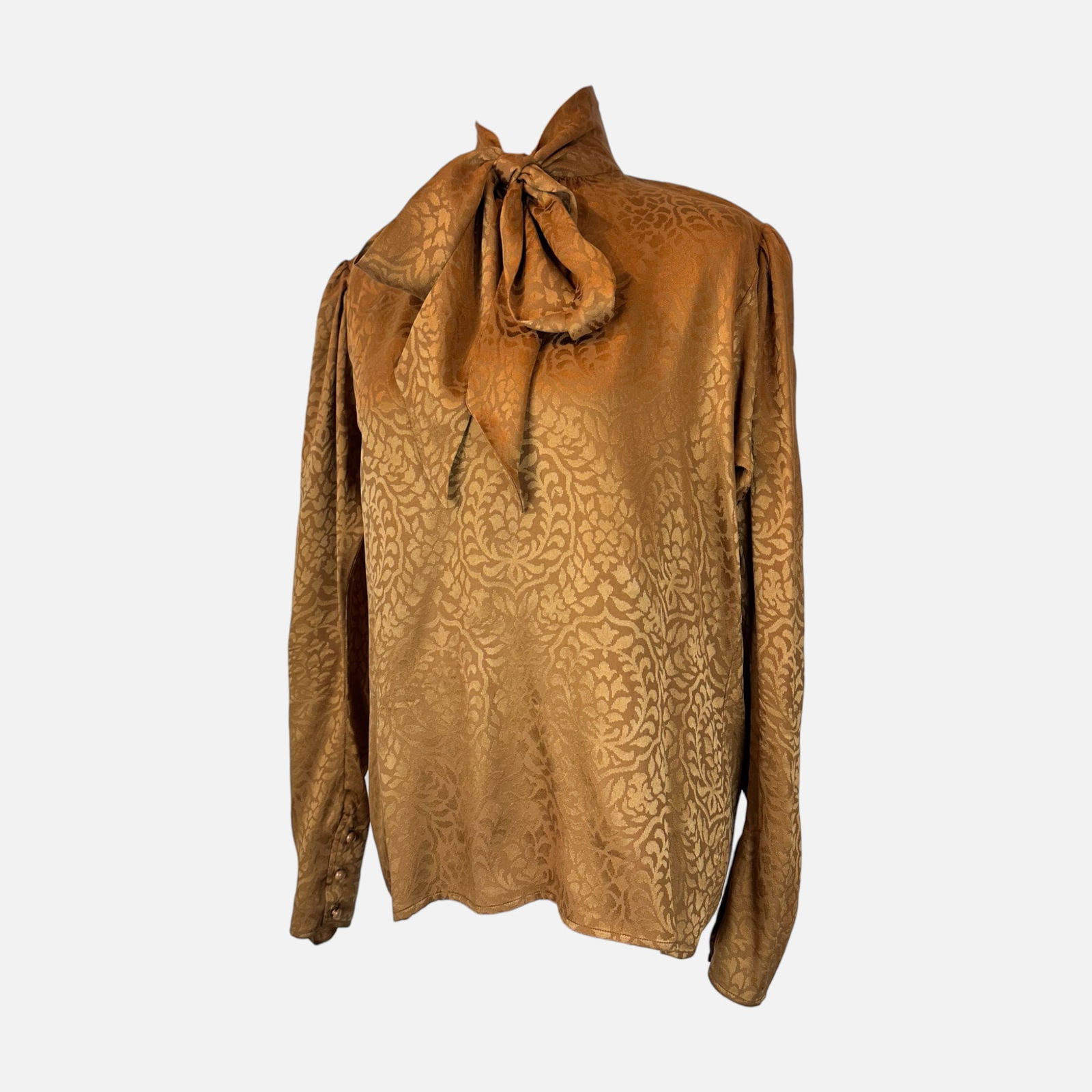 Yves Saint Laurent Vintage Copper Brown Silk Blouse: Very good condition. Fabric tag is missing. Made in Paris. Top measures 25.5 inches long, 20 inches at the waist, 20 inches at the bust, and 17 inches at the shoulder. For shipping, we highly recommen