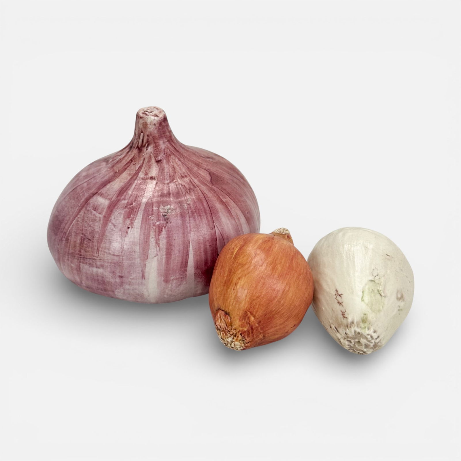 Three Mary Kirk Kelly Realistic Ceramic Onion Vegetable Sculptures: Mary Kirk Kelly (American, 1918-2013), two smaller onions signed as shown. Included dimensions for largest onion.For shipping, we highly recommend Donald Camden at UPS Store 4608. Alternatively, reach