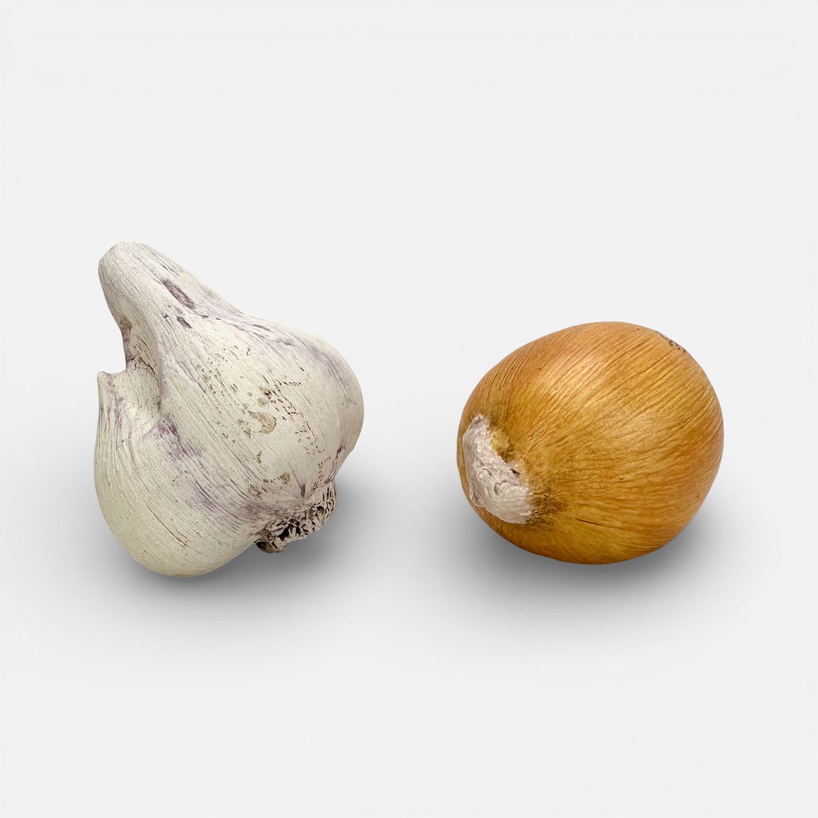 Mary Kirk Kelly Realistic Ceramic Garlic and Onion Vegetable Sculptures: Mary Kirk Kelly (American, 1918-2013), each signed as shown. Garlic measurements included in listing.For shipping, we highly recommend Donald Camden at UPS Store 4608. Alternatively, reach out to one