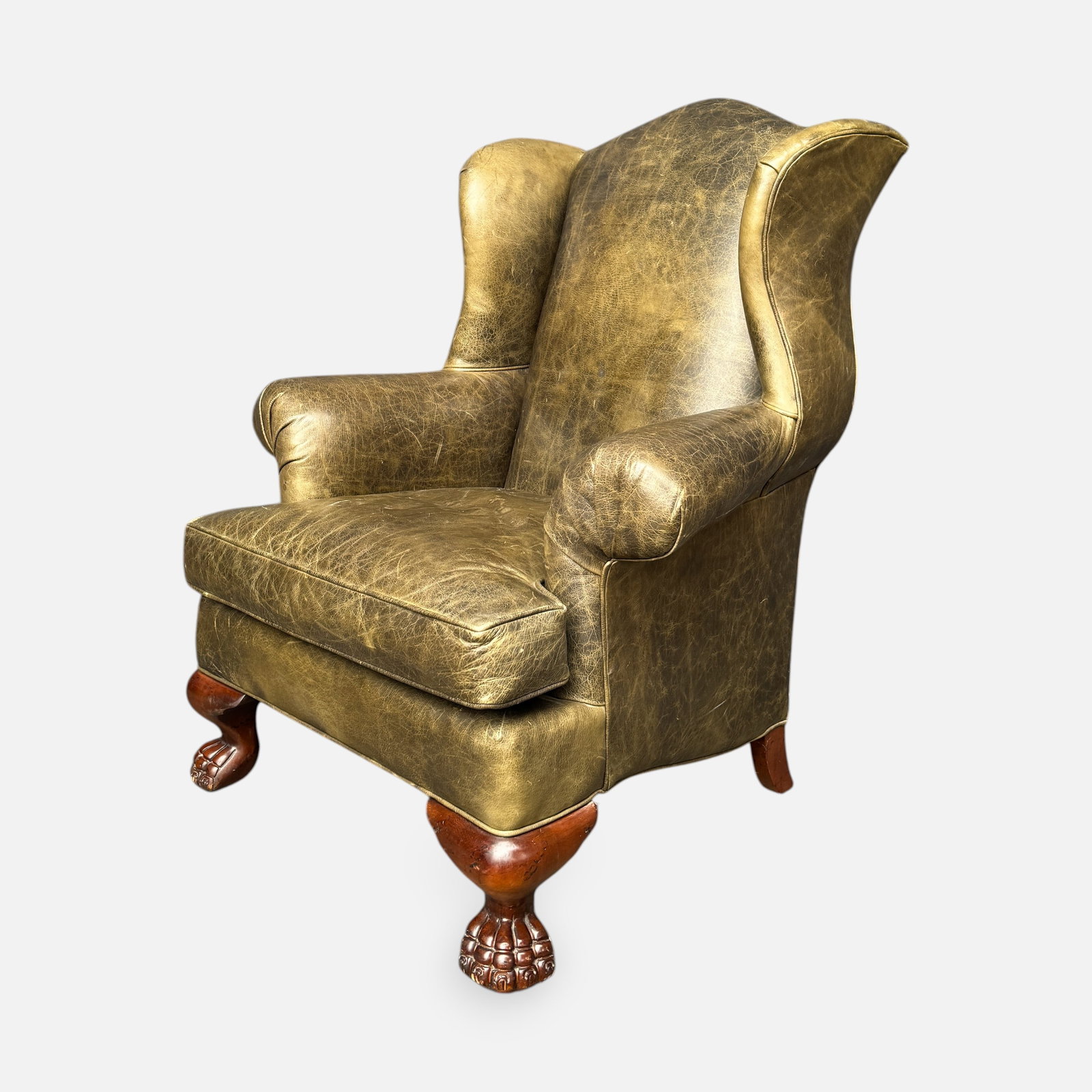 Wingback Olive Leather Library Armchair w/Paw Feet: Good overall condition, with discoloration, scuffs, and scratches.For shipping, we highly recommend Donald Camden at UPS Store 4608. Alternatively, reach out to one of our preferred shippers listed at