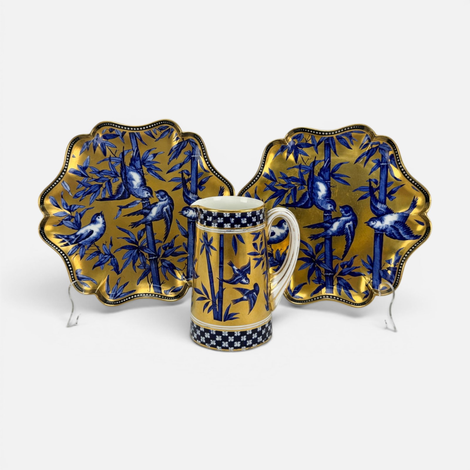 Pair Antique Coalport Plates & Pitcher w/Birds on Bamboo Leaves Against Gilt Gold Ground: Overall very good original condition, with the handle showing repair. Measurement is for the slightly larger plate. Pitcher: 6" x 4 1/2" x 3 3/4". For shipping, we highly recommend Donald Camden at UP
