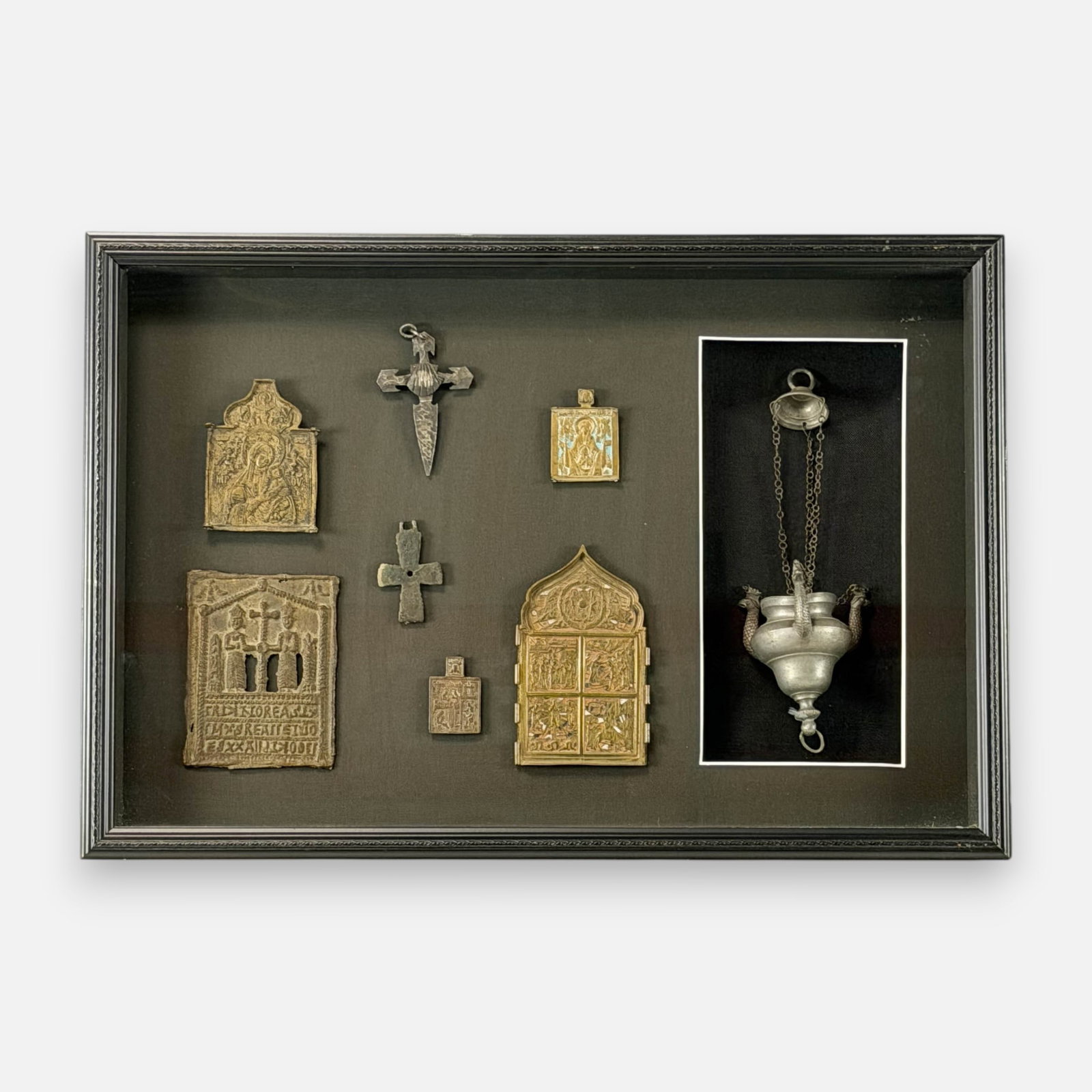 Group of Eight Antique Christian Icons and Artifacts in Shadowbox: Smallest icon measures approx. 2 1/4" high, lamp measures approx. 12" high. For shipping, we highly recommend Donald Camden at UPS Store 4608. Alternatively, reach out to one of our preferred shippers