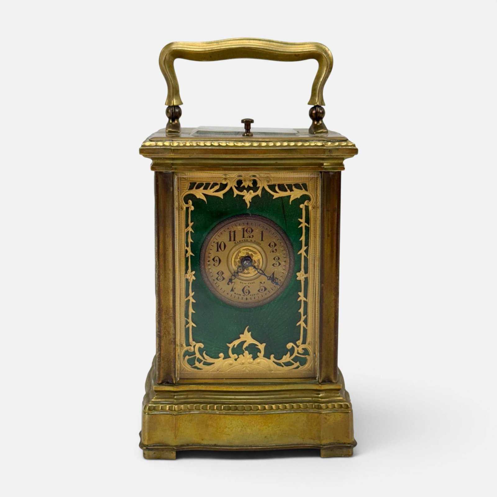 Antique Hamann & Koch Guilloche Enamel, Brass, and Glass Carriage Travel Clock: Made in Paris. See photo showing broken glass panel. Measures approx. H: 7", W: 3 3/4", D: 3 1/2". For shipping, we highly recommend Donald Camden at UPS Store 4608. Alternatively, reach out to one of