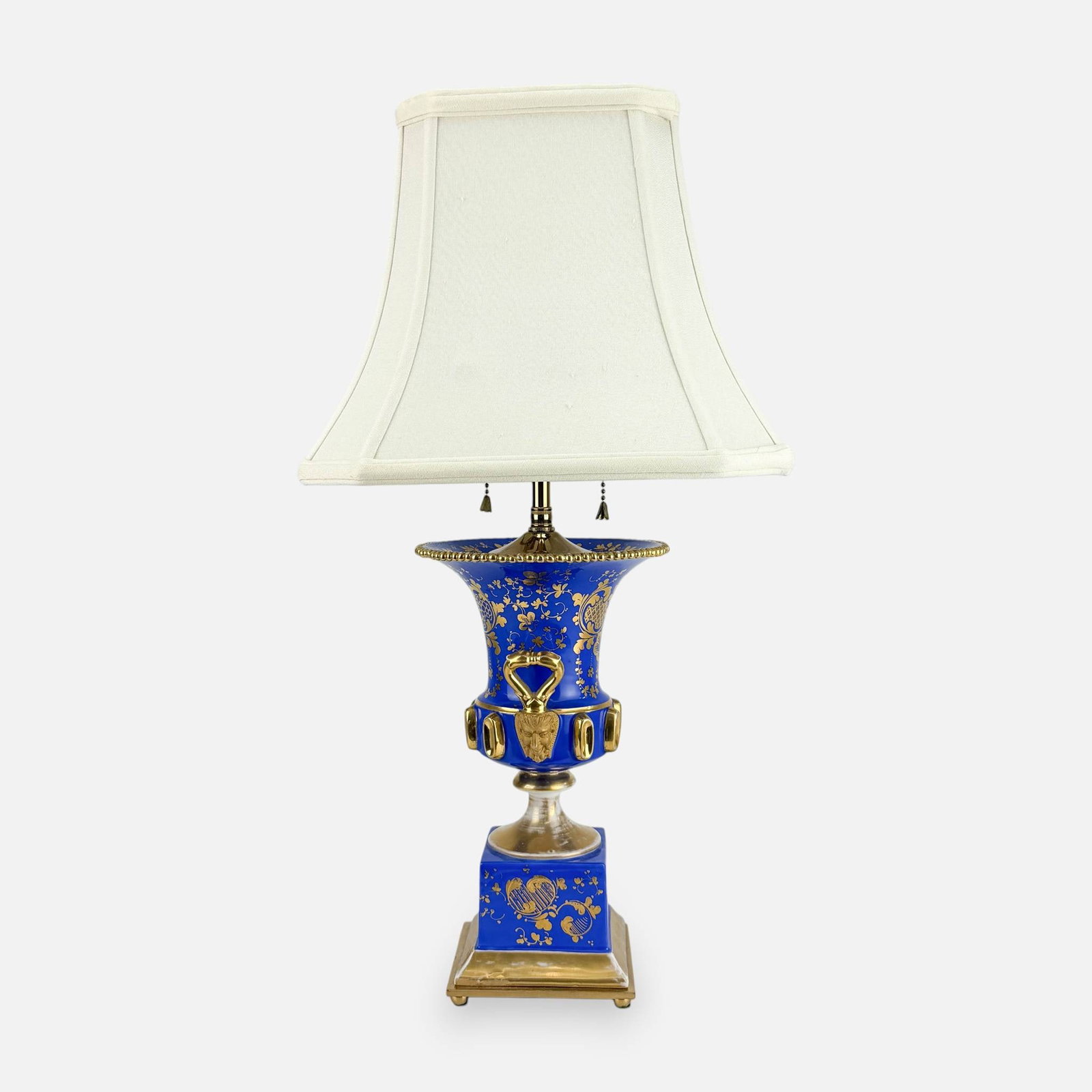 Old Paris Hand-Painted Porcelain Vase Table Lamp w/Satyr Face Handles: Good, with age-appropriate gilt loss. No chips, cracks, or repairs. Measures approx. 21 1/2" by 6 3/4" without shade and standard adjusted to minimum height. Porcelain section measures approx. 11 1/4"