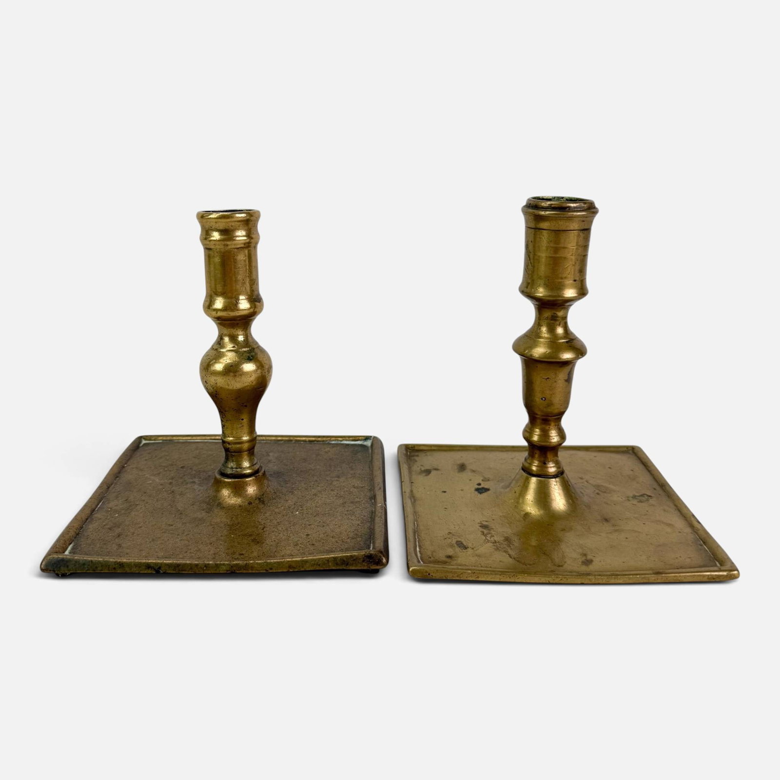 Two Antique 17thC Brass Candlesticks w/Square Bases: Ca. 17thC. Good, with shown age-appropriate surface wear and discoloration. For shipping, we highly recommend Donald Camden at UPS Store 4608. Alternatively, reach out to one of our preferred