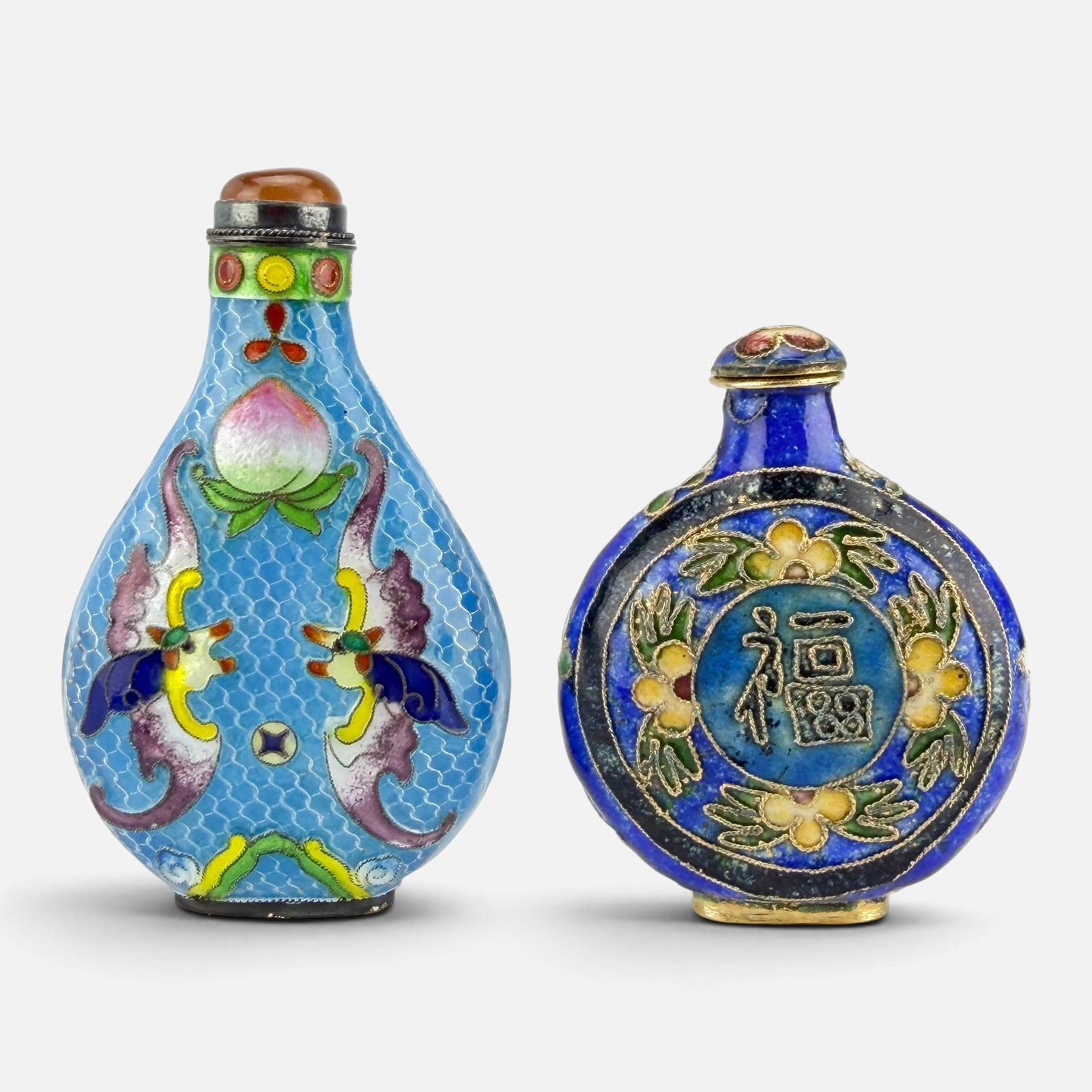 Two Chinese Cloisonne Enameled Silver Snuff Bottles: Taller bottle marked "SILVER" as shown. Taller bottle measures approx. H: 3", W: 1 3/4", D: 3/4". Shorter bottle measures approx. 2 3/8". For shipping, we highly recommend Donald Camden at UPS Store 4